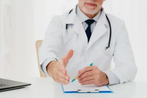 doctor holding out his hand while sitting 11zon